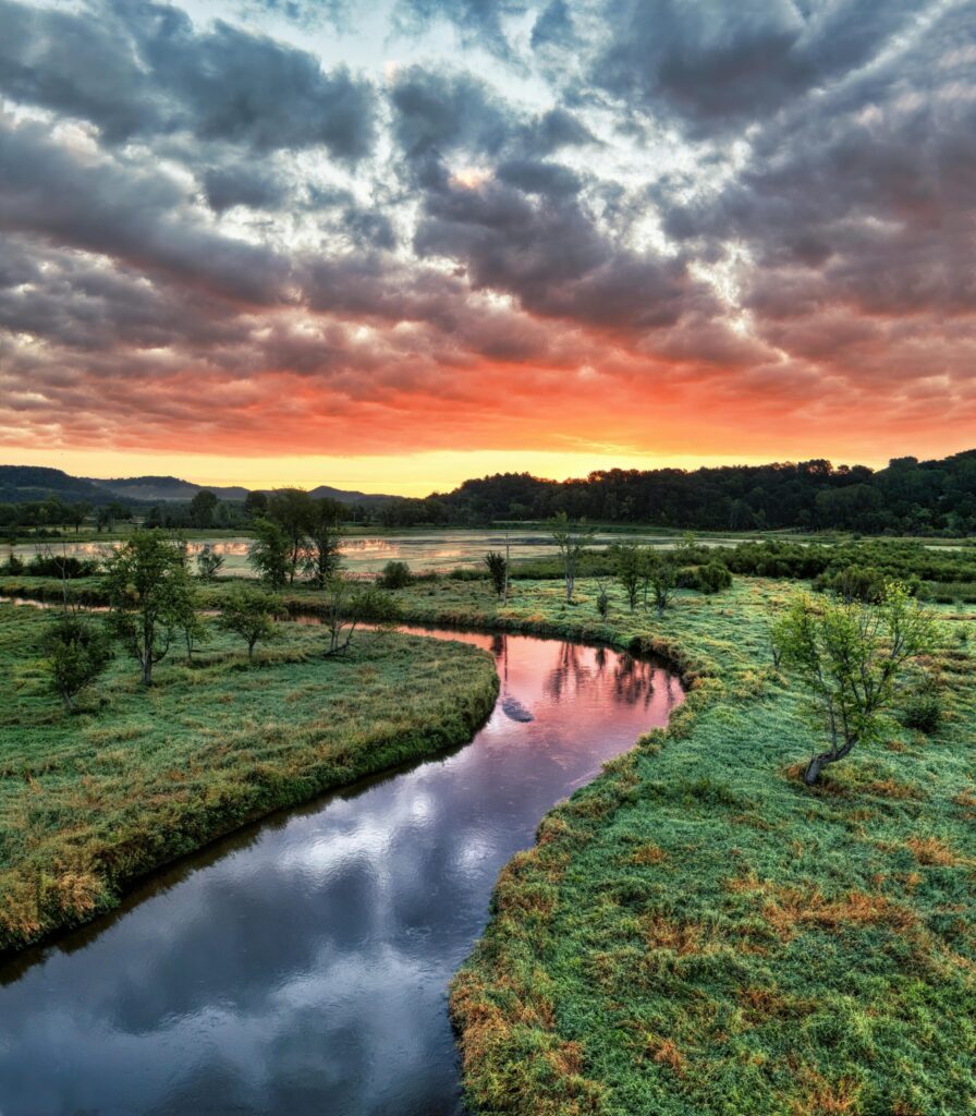 pexels photo 14375875 14375875 Stunning sunset over a winding river landscape in Tell, Wisconsin with vibrant colors and lush greenery.